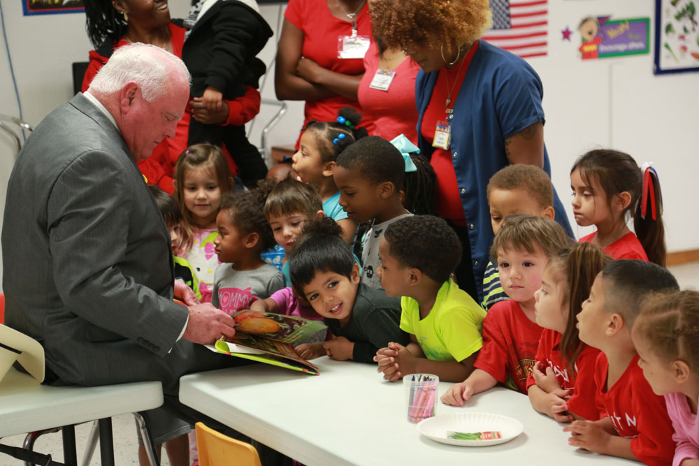 Commissioner Miller reads a book a class at Kids R Fun.